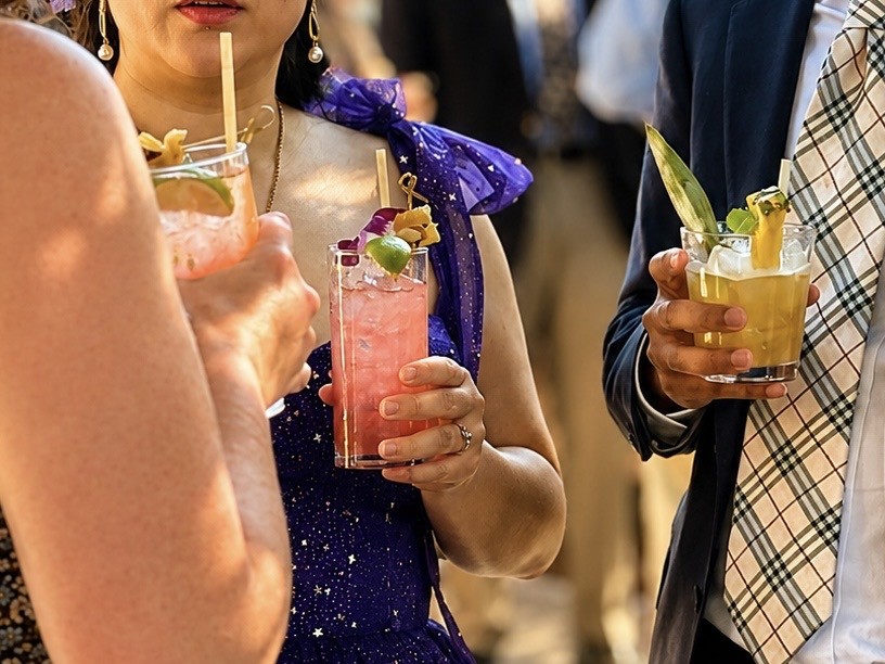 Wedding guests holding colorful signature beverages
