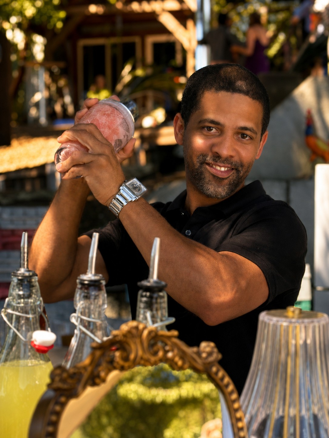 Jorge shaking a cocktail behind the bar