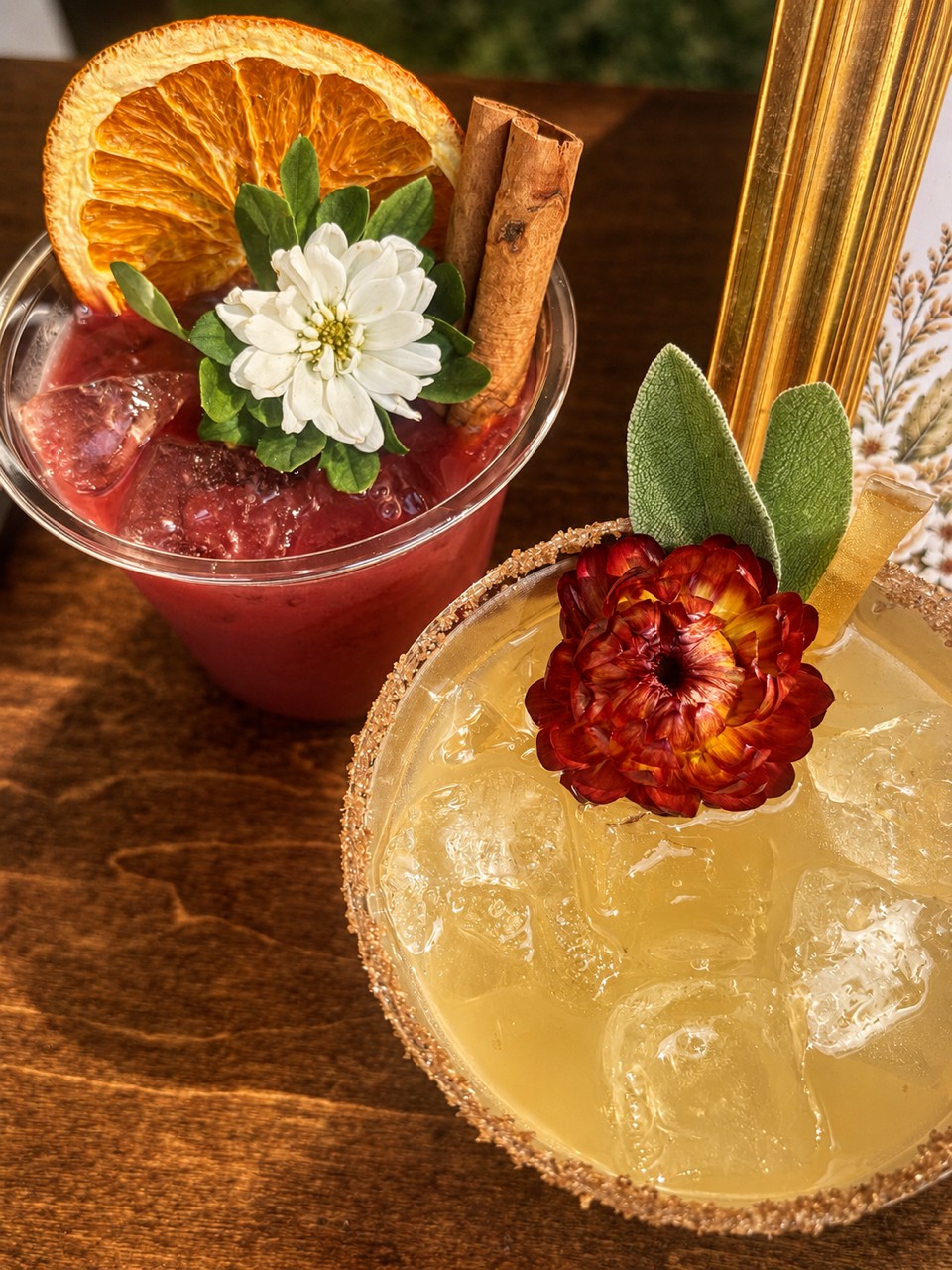 Signature beverages with citrus, flowers, and fresh garnishes
