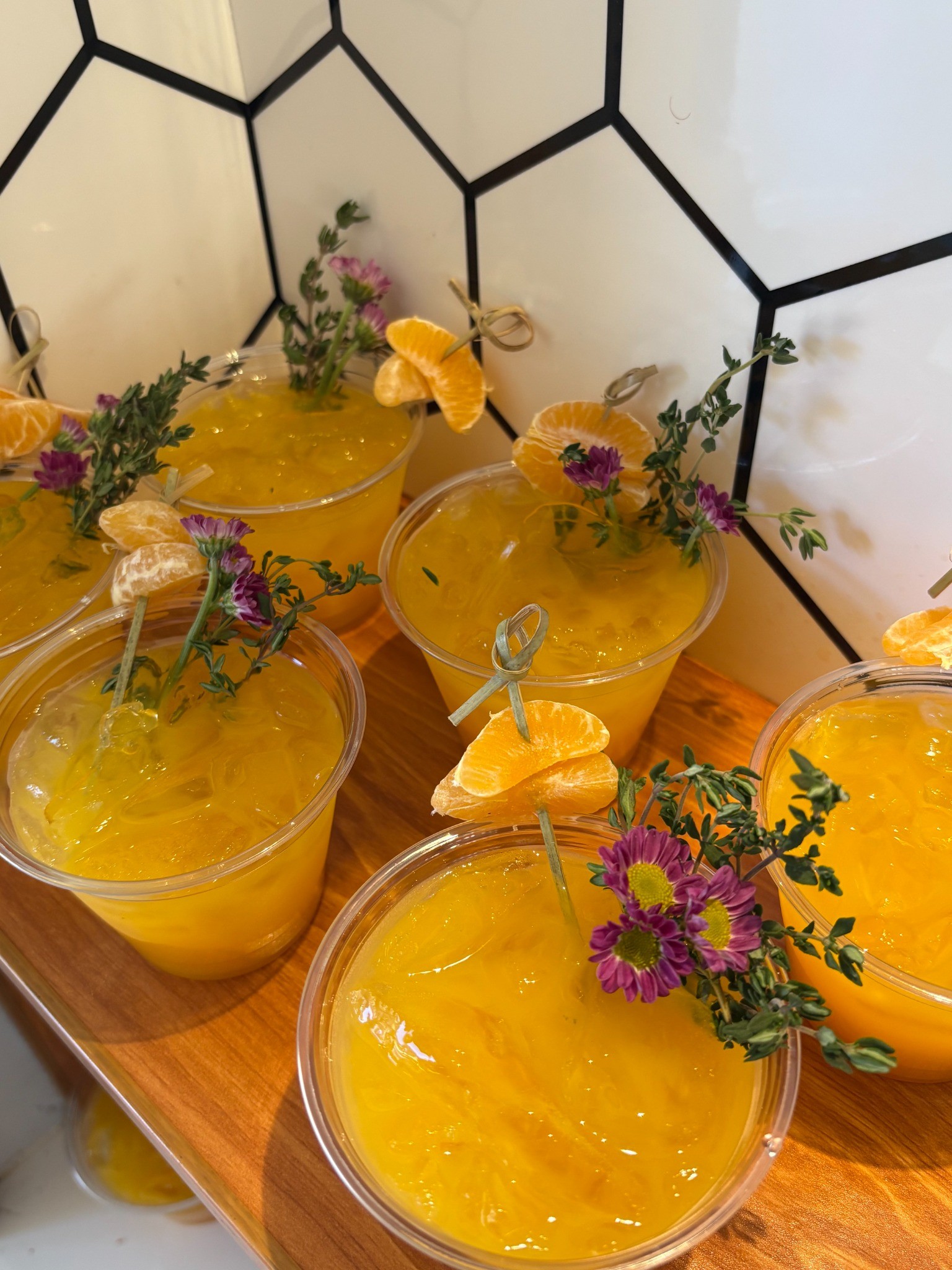Yellow cocktails garnished with fresh flowers